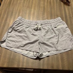 Light purple/lavender Vuori running Clementine shorts.